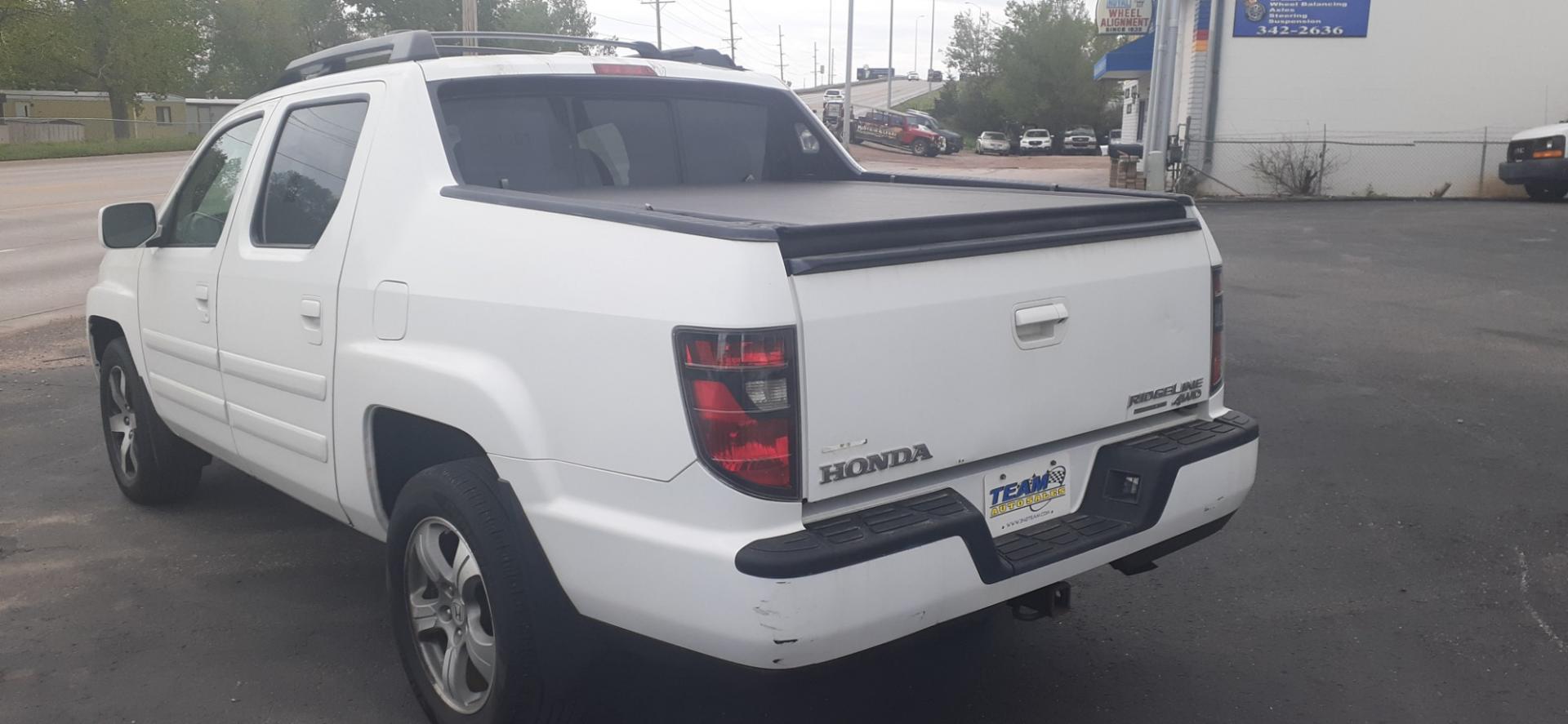 2014 Honda Ridgeline RTL-S (5FPYK1F67EB) with an 3.5L V6 SOHC 24V engine, 5-Speed Automatic transmission, located at 2015 Cambell Street, Rapid City, SD, 57701, (605) 342-8326, 44.066433, -103.191772 - Photo#2